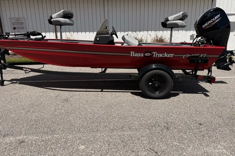 The Image of Red 2027 Tracker Bass Tracker Classic XL boat with Mercury engine on trailer. - 0