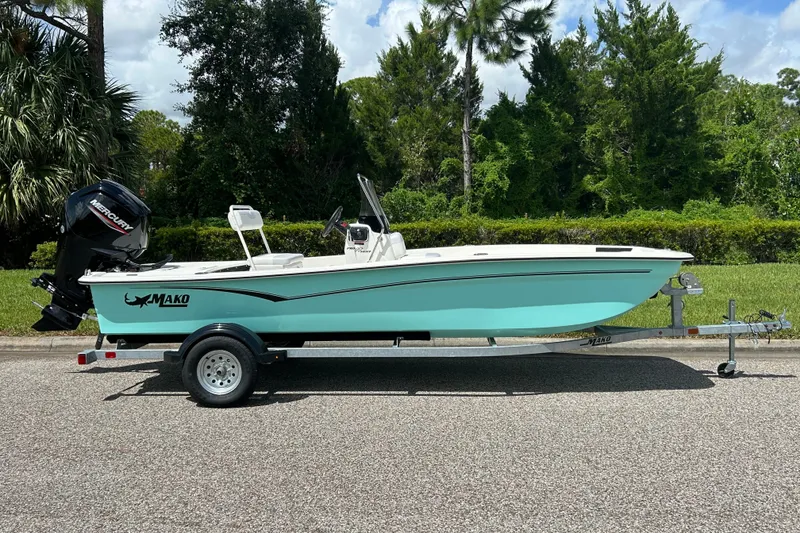 The Image of 2027 Mako Pro Skiff 17 CC boat on trailer, parked outdoors. - 0