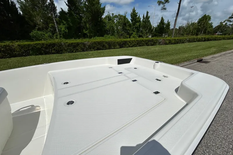 Slide: The Image of 2027 Mako Pro Skiff 17 CC boat deck, featuring spacious storage compartments and sleek design. - 10