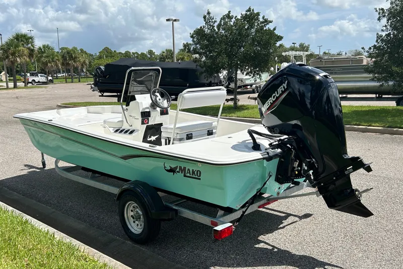 Slide: The Image of 2027 Mako Pro Skiff 17 CC boat with Mercury engine on trailer in parking lot. - 5