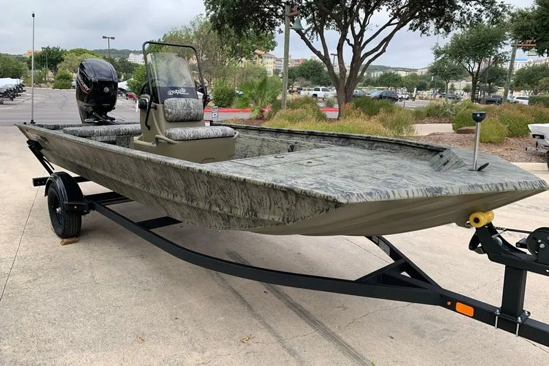 The Image of 2027 Tracker Grizzly 1860 CC boat on trailer, parked outdoors. - 0