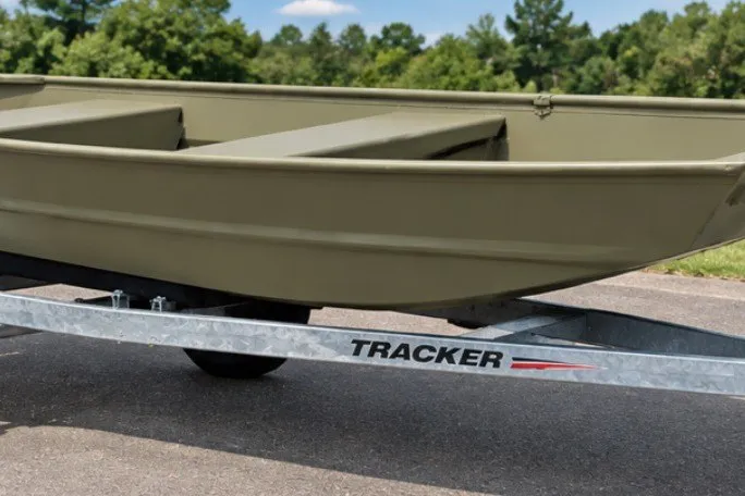 The Image of 2027 Tracker Grizzly 12 Jon boat on trailer, parked outdoors. - 0