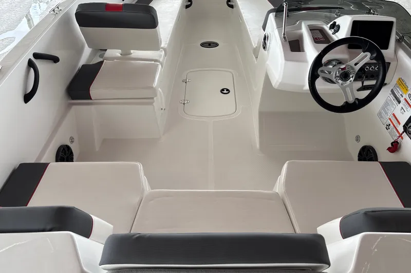 Slide: The Image of 2027 Tahoe T18 boat interior with modern seating and steering console. - 14