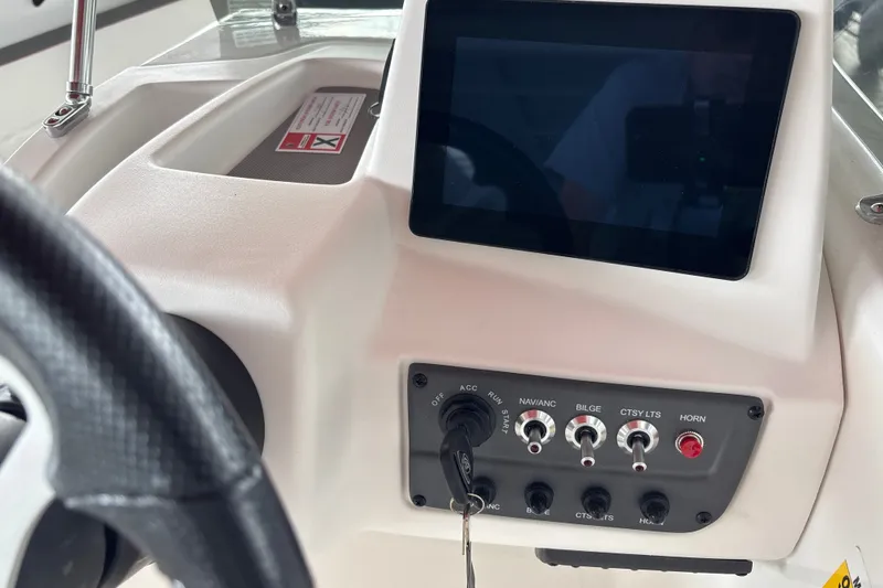 Slide: The Image of 2027 Tahoe T18 boat dashboard with touchscreen and control switches. - 16