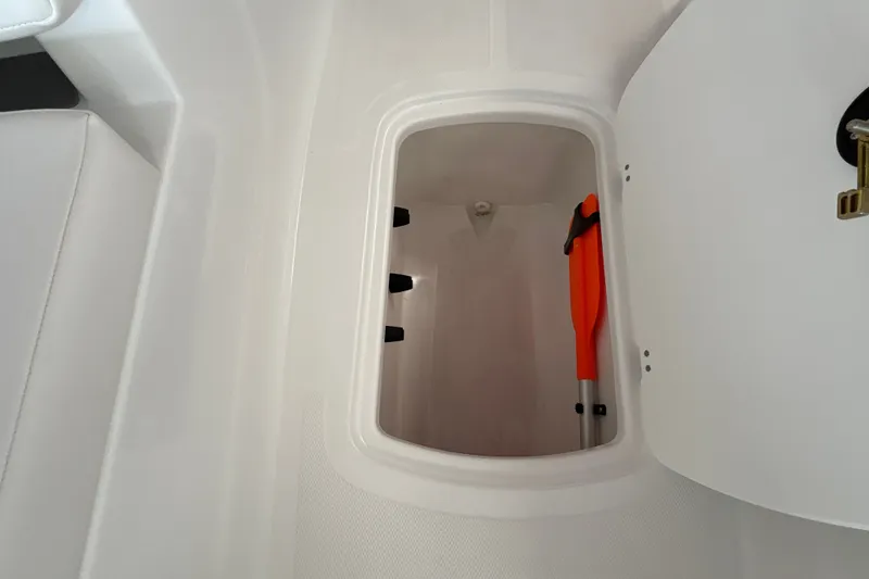 Slide: The Image of 2027 Tahoe T18 boat storage compartment with paddle inside. - 25