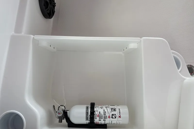 Slide: The Image of 2027 Tahoe T18 boat compartment with mounted fire extinguisher and speaker. - 22