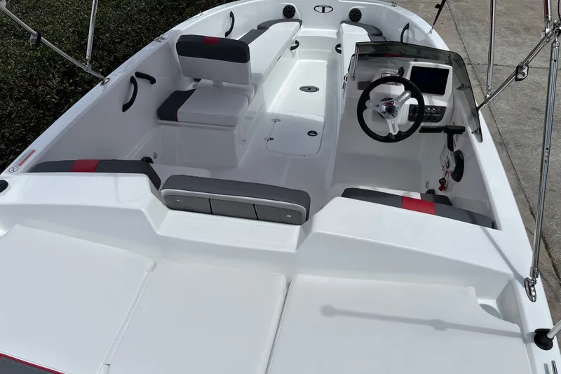 Slide: The Image of 2027 Tahoe T18 boat interior with modern seating and steering console. - 13