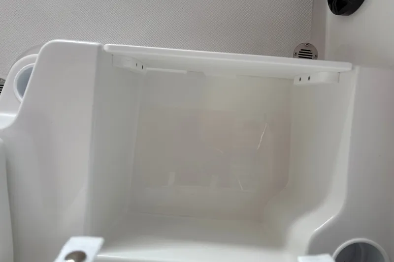 Slide: The Image of 2027 Tahoe T18 boat interior storage compartment, featuring sleek white design. - 21