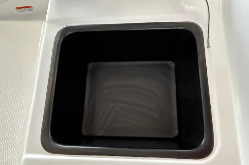 Slide: The Image of Storage compartment in 2027 Tahoe T18 boat, featuring a sleek black interior design. - 26