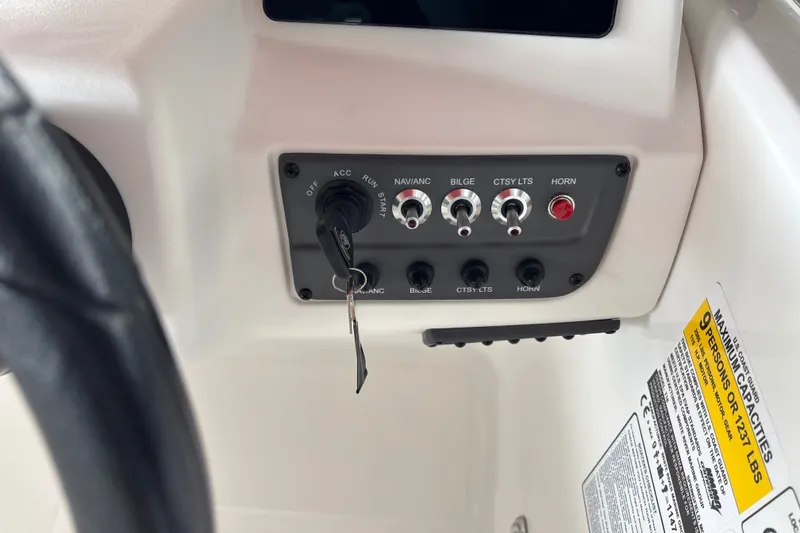 Slide: The Image of Control panel of a 2027 Tahoe T18 boat with ignition and switches. - 17