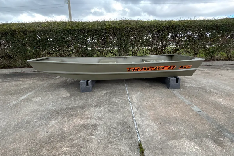 The Image of 2027 Tracker Grizzly 12 Jon boat on concrete blocks, outdoor setting. - 0