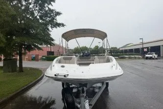 Slide: The Image of Tahoe 1950 boat, 2027 model, on trailer in parking lot, overcast day. - 1
