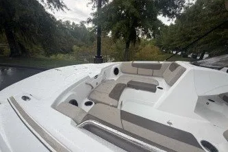 Slide: The Image of 2027 Tahoe 1950 boat with spacious seating, set against a lush, green backdrop. - 8