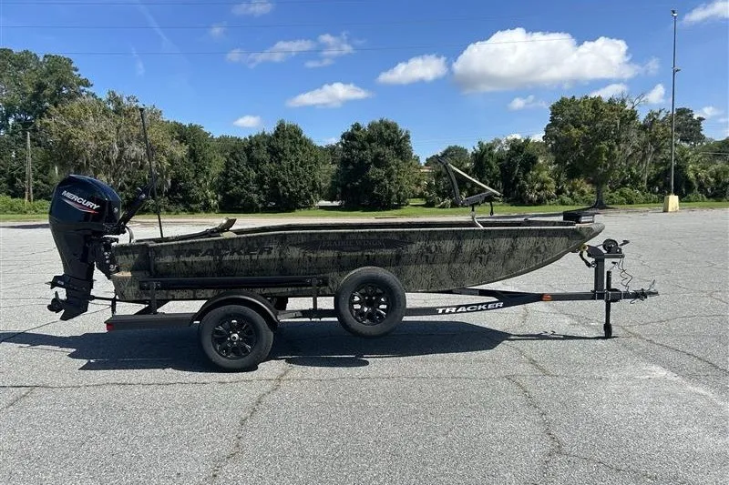 The Image of 2027 Tracker Grizzly 1650 T Prairie Wings Edition boat on trailer in parking lot. - 0