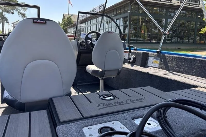 Slide: The Image of 2027 Tracker Pro Guide V-175 Combo boat interior with seating and steering console. - 16