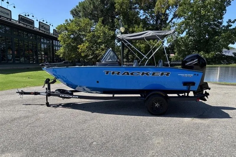 The Image of 2027 Tracker Pro Guide V-175 Combo boat on trailer, parked outdoors. - 0