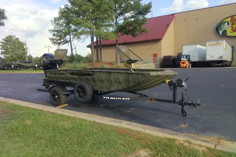 Slide: The Image of 2027 Tracker Grizzly 1650 T Prairie Wings Edition boat on trailer in parking lot. - 43
