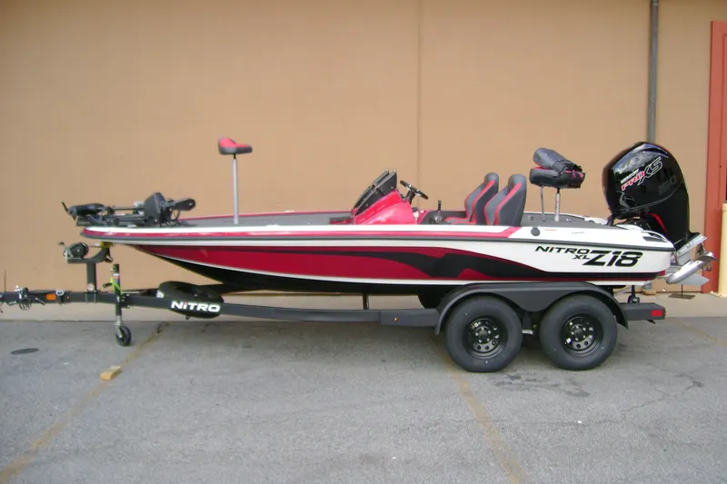 Slide: The Image of 2027 Nitro Z18 XL Pro bass boat on trailer, red and white design. - 1