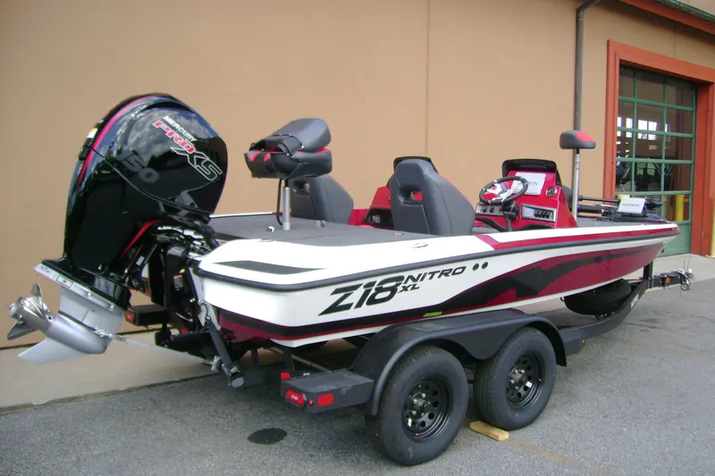 Slide: The Image of 2027 Nitro Z18 XL Pro boat with powerful engine, parked on trailer. - 5