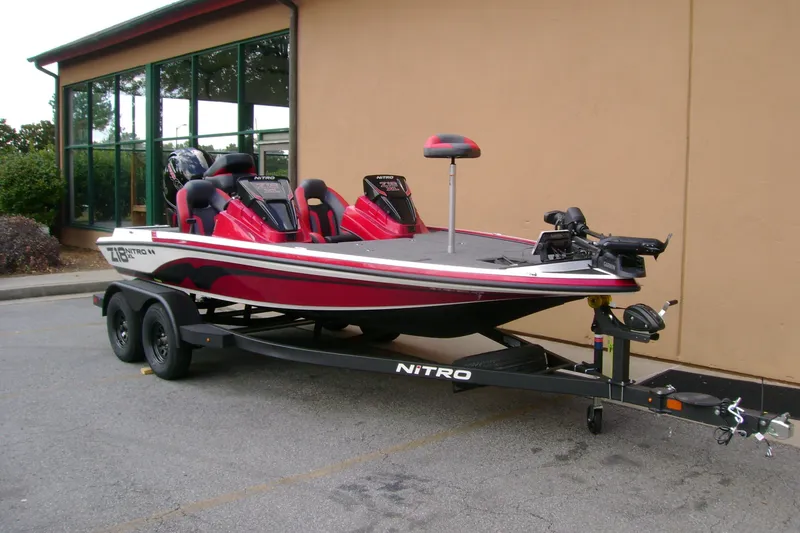 Slide: The Image of 2027 Nitro Z18 XL Pro fishing boat on trailer, parked outside a building. - 2