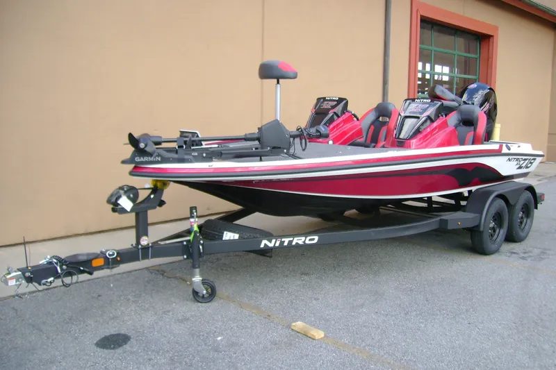 Slide: The Image of 2027 Nitro Z18 XL Pro fishing boat on trailer, red and black design. - 3