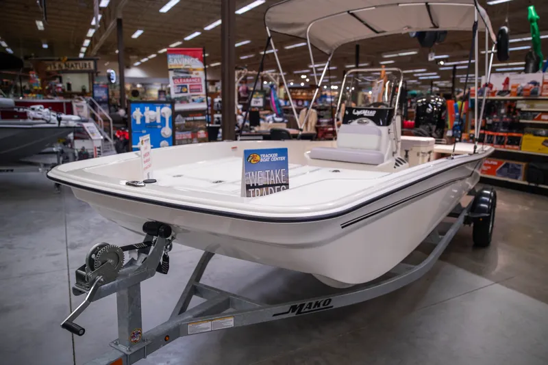 Slide: The Image of 2027 Mako Pro Skiff 17 CC boat displayed in a showroom on a trailer. - 3