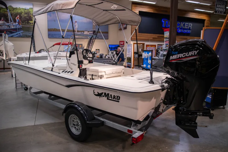 Slide: The Image of 2027 Mako Pro Skiff 17 CC boat with Mercury engine on display in showroom. - 4