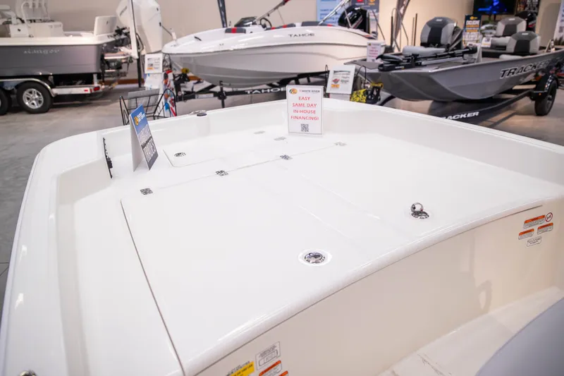 Slide: The Image of 2027 Mako Pro Skiff 17 CC boat displayed at a showroom with financing options. - 11
