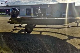 The Image of 2027 Tracker Grizzly 1860 CC boat on trailer in sunny outdoor setting. - 0