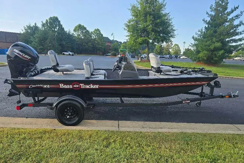 The Image of 2027 Tracker Bass Tracker Classic XL boat on trailer, parked outdoors. - 0