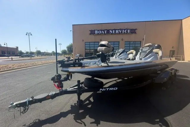 Slide: The Image of 2027 Nitro Z19 XL Pro boat parked outside a boat service center. - 3