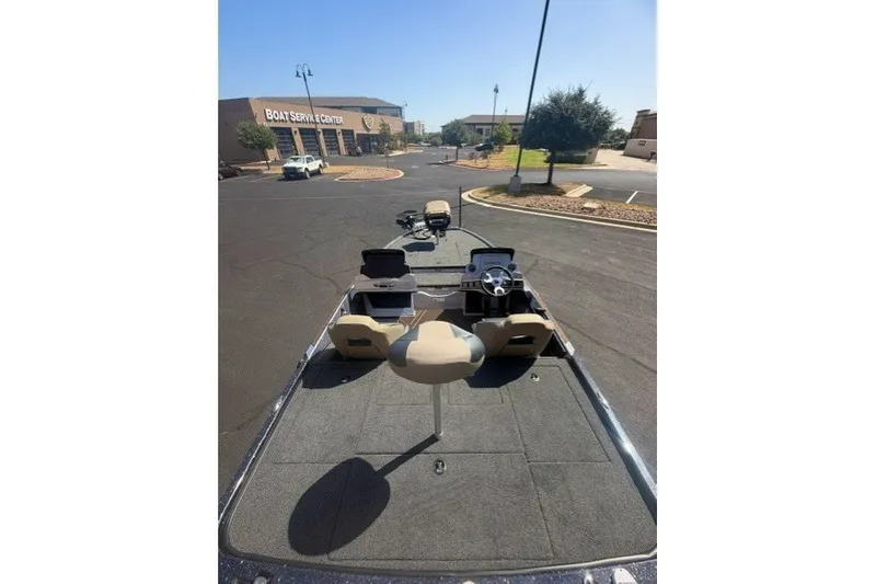Slide: The Image of 2027 Nitro Z19 XL Pro boat parked near a boat service center. - 6