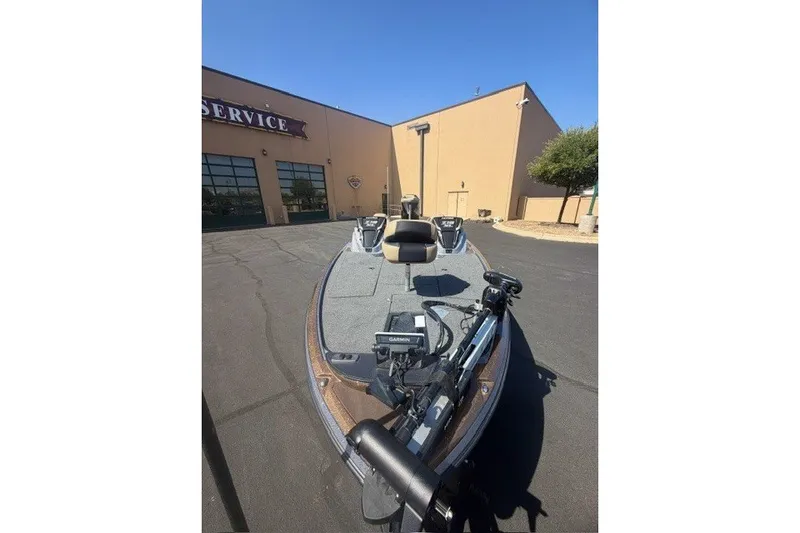 Slide: The Image of 2027 Nitro Z19 XL Pro boat parked outside service center under clear blue sky. - 5