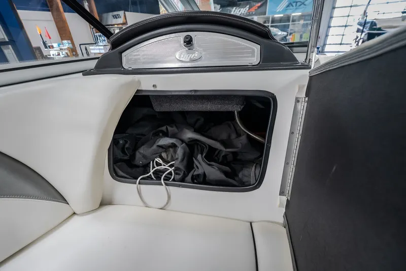 Slide: The Image of Storage compartment in a 2008 Tigé 24Ve boat, featuring interior upholstery and equipment. - 21