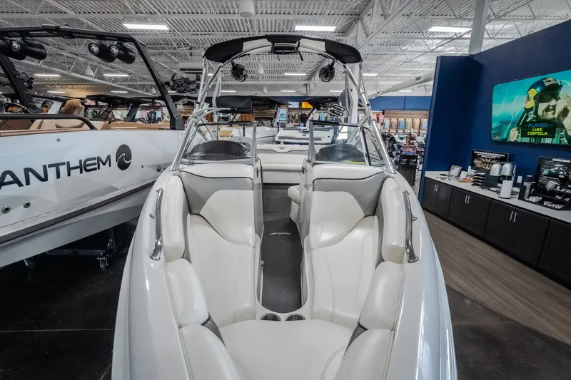 Slide: The Image of 2008 Tigé 24Ve boat interior with white seating, displayed in a showroom. - 28