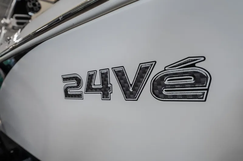 Slide: The Image of Close-up of 2008 Tigé 24Ve boat model emblem on white surface. - 26