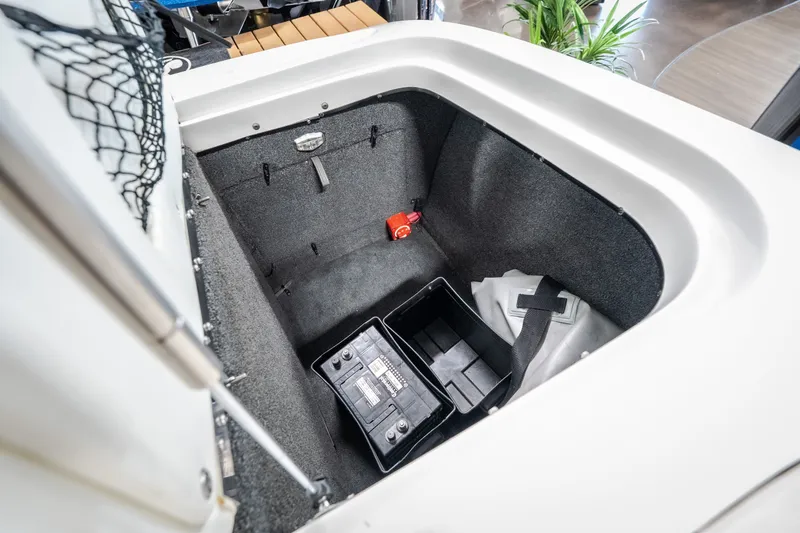 Slide: The Image of Storage compartment of a 2008 Tigé 24Ve boat with battery and accessories. - 24
