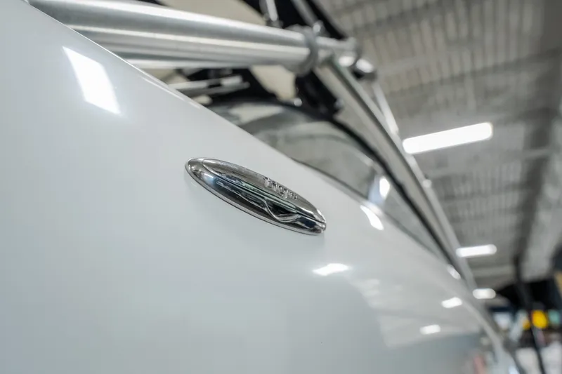 Slide: The Image of Close-up of a 2008 Tigé 24Ve boat emblem in a well-lit indoor setting. - 27