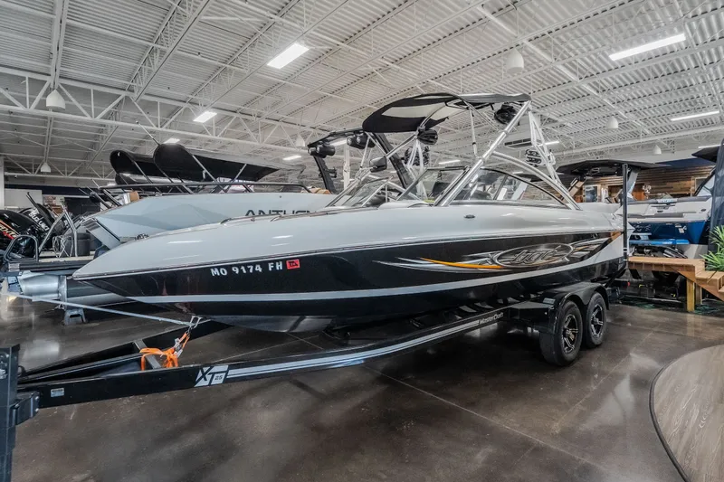 The Image of 2008 Tigé 24Ve boat displayed indoors on a trailer. - 2