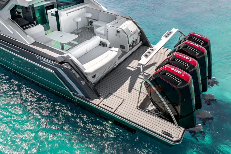 Slide: The Image of 2022 Formula 500 Super Sport Crossover yacht with powerful outboard engines on turquoise water. - 15