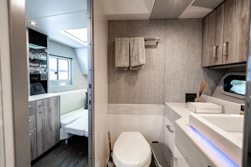 Slide: The Image of Luxurious 2022 Formula 500 Super Sport Crossover yacht interior with modern bathroom and seating area. - 56
