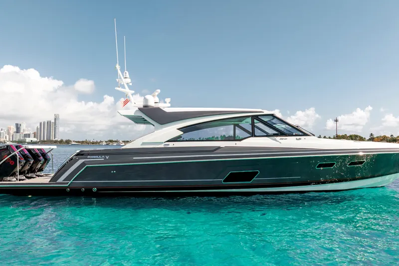Slide: The Image of 2022 Formula 500 Super Sport Crossover yacht on clear blue water, city skyline in background. - 6