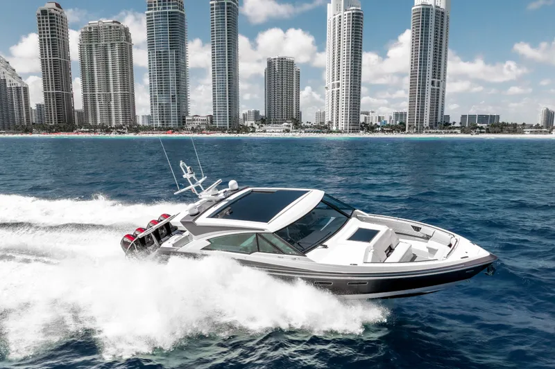 Slide: The Image of 2022 Formula 500 Super Sport Crossover cruising near city skyline on blue ocean. - 4