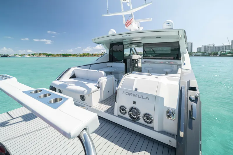 Slide: The Image of 2022 Formula 500 Super Sport Crossover yacht on turquoise water, featuring luxurious seating and sleek design. - 42