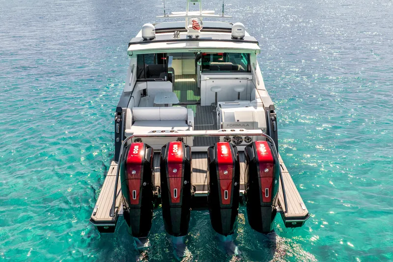 Slide: The Image of 2022 Formula 500 Super Sport Crossover boat with four powerful engines on clear blue water. - 2