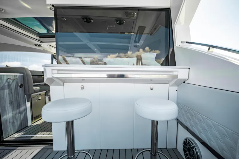 Slide: The Image of 2022 Formula 500 Super Sport Crossover yacht interior with bar stools and modern design. - 35