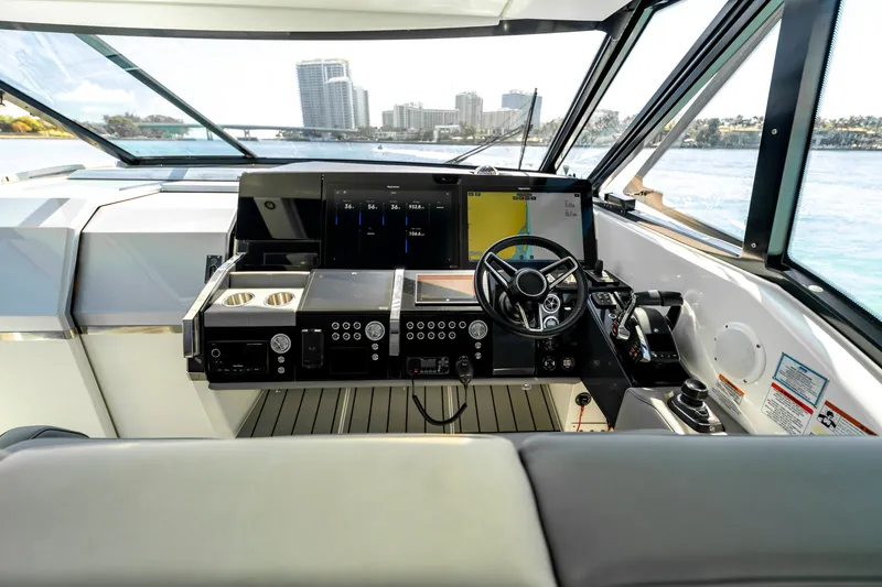 Slide: The Image of Cockpit of 2022 Formula 500 Super Sport Crossover yacht with modern controls and navigation screens. - 26