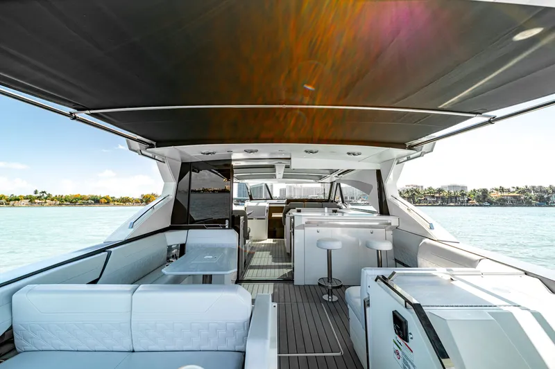 Slide: The Image of 2022 Formula 500 Super Sport Crossover yacht interior with seating and bar area. - 49