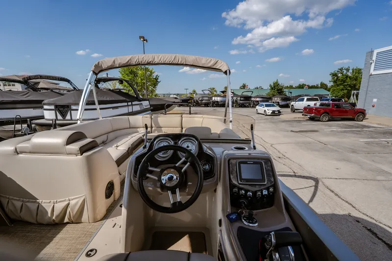 Slide: The Image of 2017 Princecraft Vogue 25 XT pontoon boat interior with steering wheel and dashboard controls. - 30