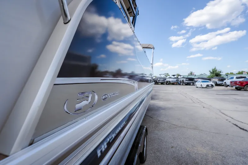 Slide: The Image of 2017 Princecraft Vogue 25 XT boat reflecting blue sky and clouds in a parking lot. - 16
